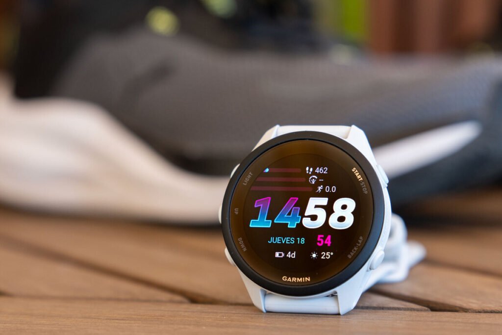 Reloj deportivo inteligente con pantalla táctil encendida, destacando el Garmin Forerunner 70 como alternativa para correr.