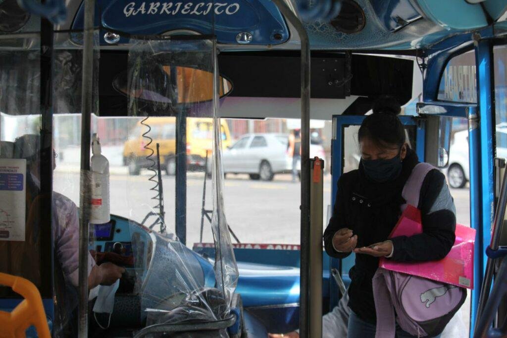 Una usuaria cancelando el valor del pasaje al ingresar a una unidad de transporte público urbano, representando el debate de la tarifa de buses en Quito 2026.