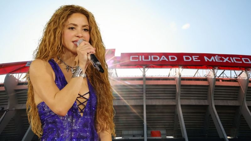 La cantante Shakira sonriendo en una conferencia de prensa sobre espectáculos musicales de la FIFA.