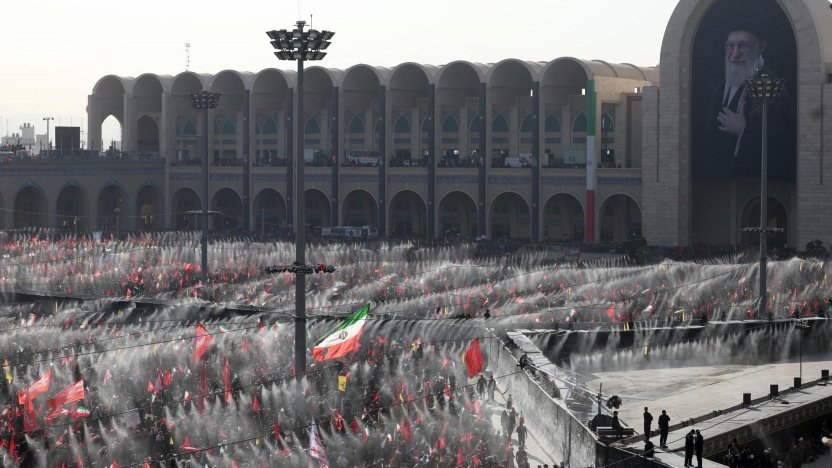 Ciudadanos en Irán sosteniendo carteles con los rostros de los ayatolás durante las exequias del líder supremo en la plaza Azadi.