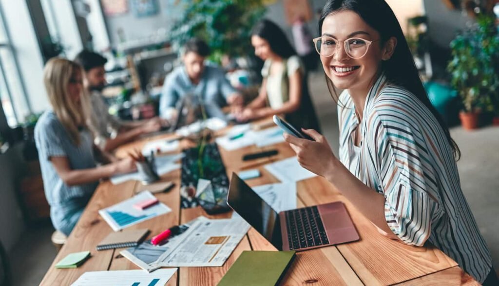 Empleados ecuatorianos trabajando en un entorno saludable que promueve la felicidad laboral como estrategia empresarial