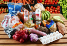 Precios de la canasta básica familiar: ¿realmente bajaron en Ecuador según el INEC? Personas comprando productos de la canasta básica familiar en un mercado de Ecuador.